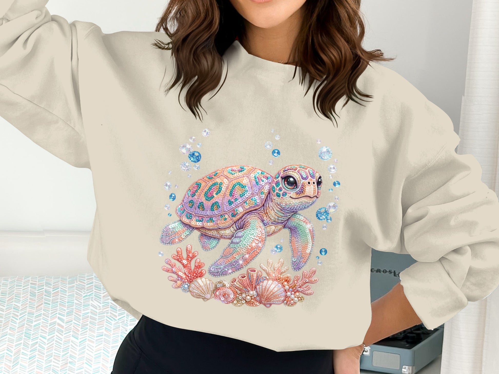 Crewneck sweatshirt with a pastel sea turtle surrounded by coral and bubbles.