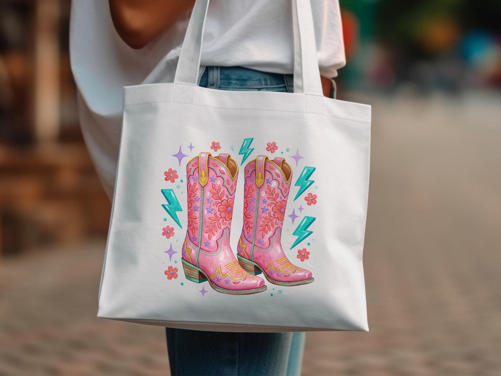 White tote bag featuring pink cowboy boots with star and lightning bolt graphics.