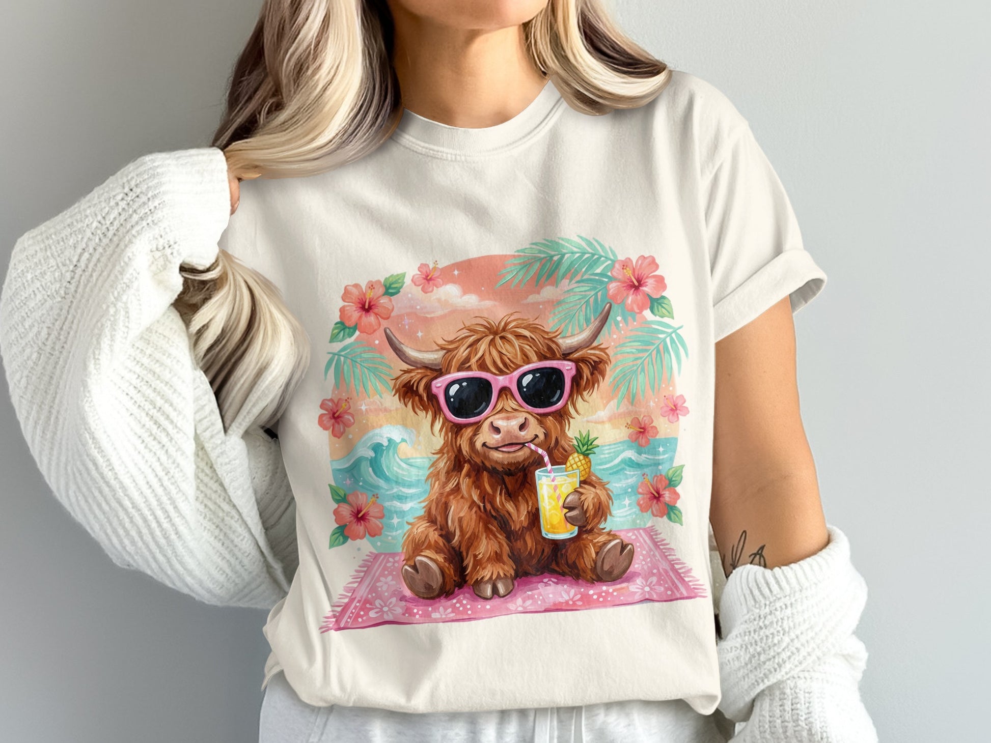 Highland cow wearing sunglasses drinks a tropical beverage on a beach.