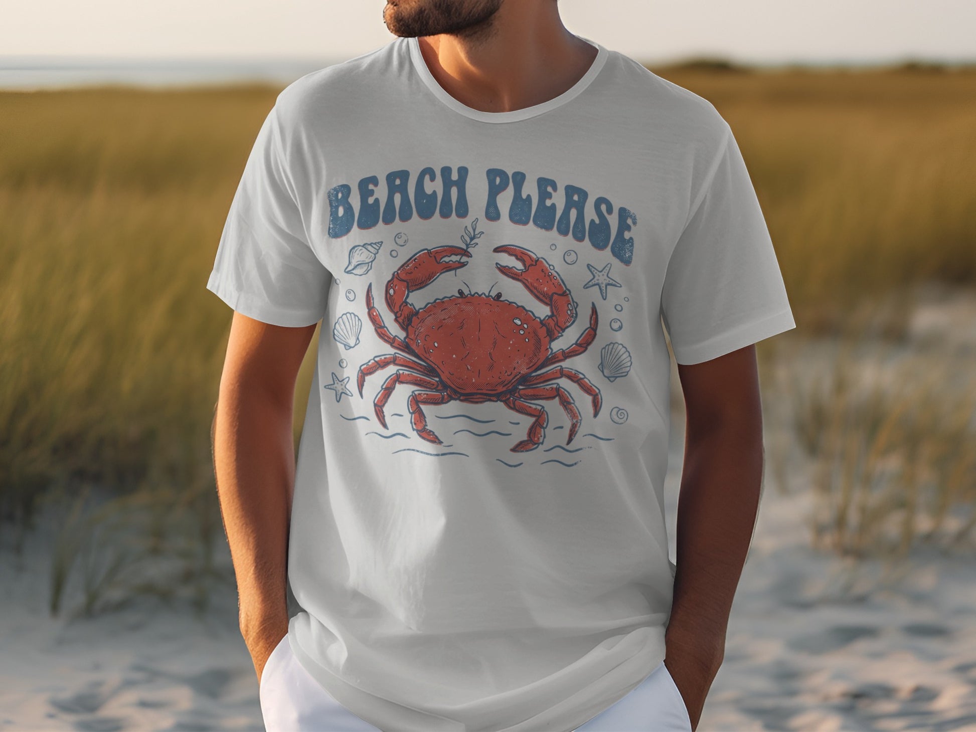 White t-shirt with graphic of red crab, seashells, and text "Beach Please".