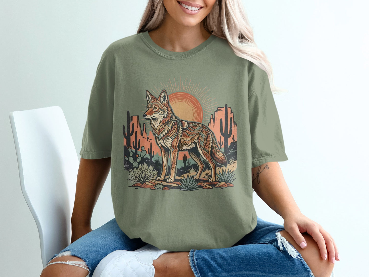 T-shirt with coyote, desert landscape, and sun graphic.