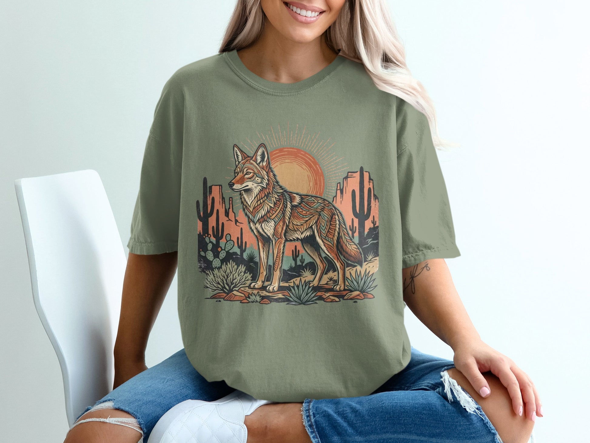 T-shirt with coyote, desert landscape, and sun graphic.