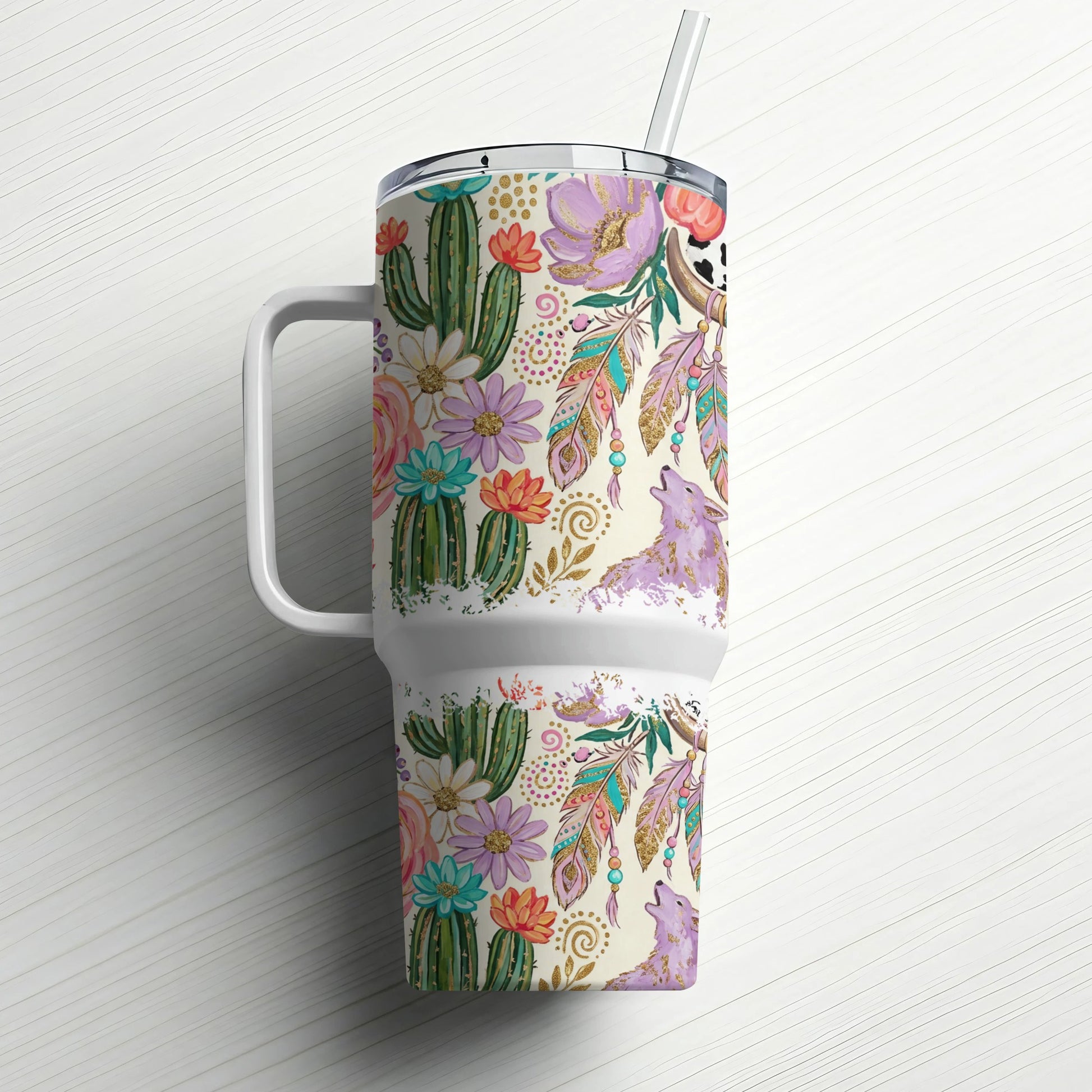 Tumbler with cacti, feathers, and howling wolf on white background.
