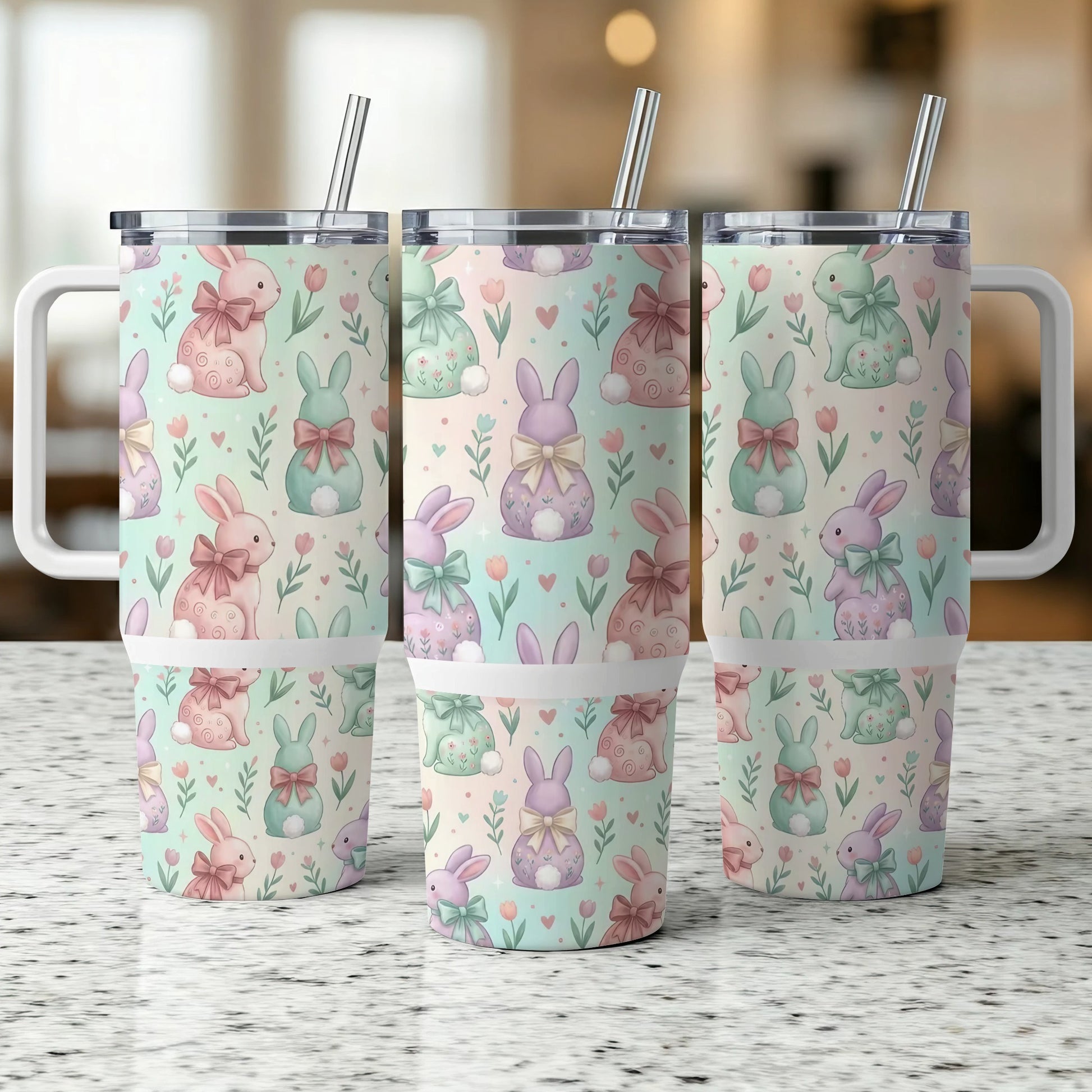 Three insulated tumblers with pastel Easter bunny and floral patterns.