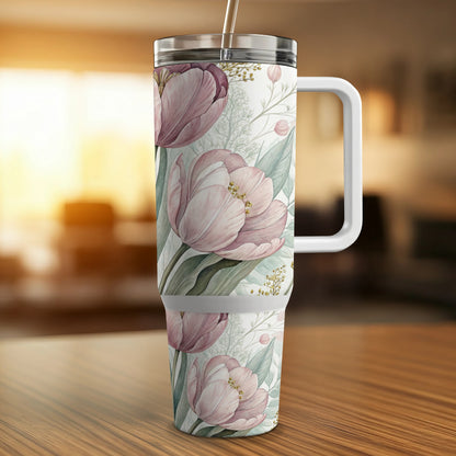 Tumbler with a pink floral pattern and a white handle.