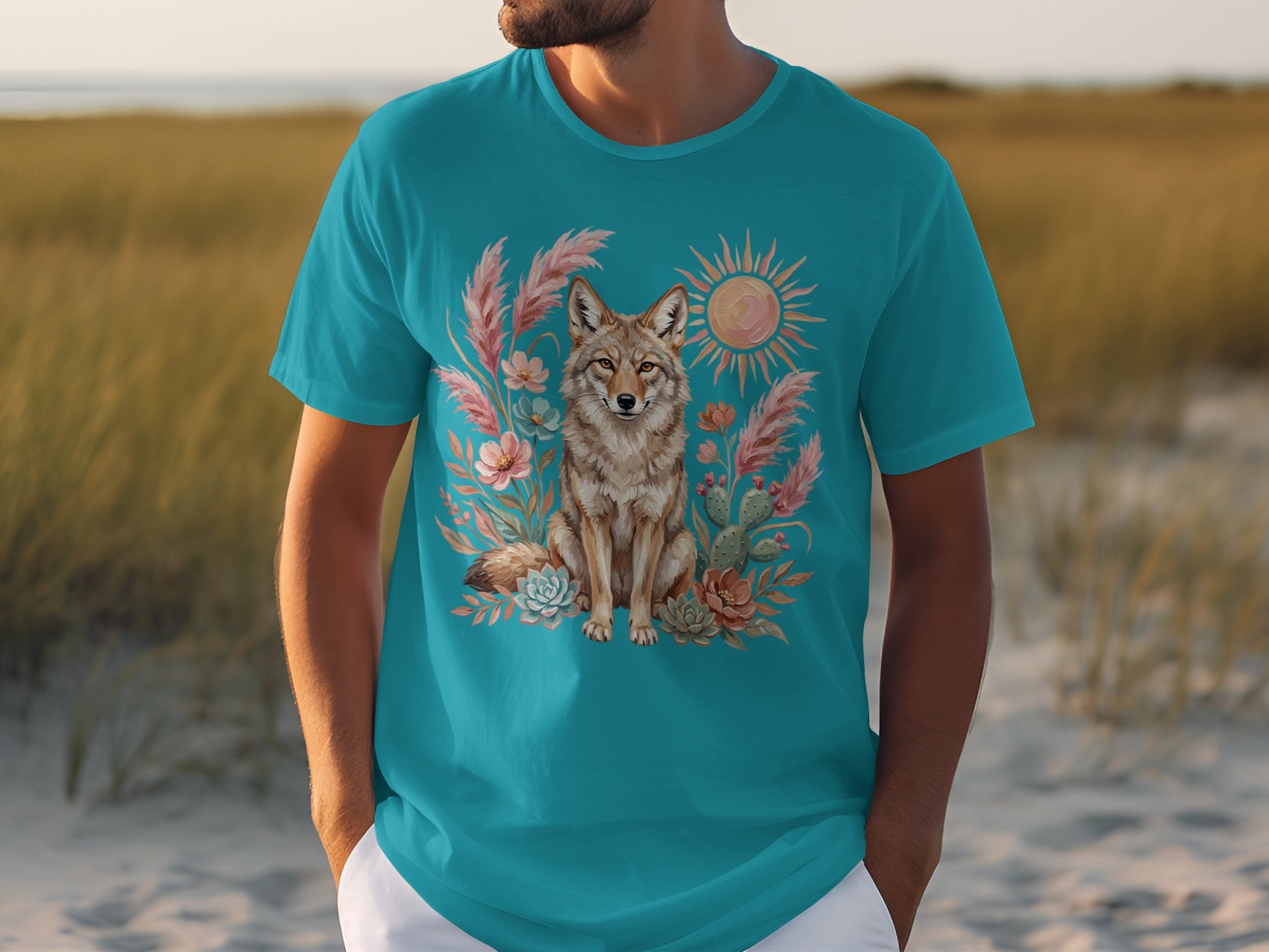 Turquoise t-shirt featuring a desert scene with a coyote, cacti, and a sun.