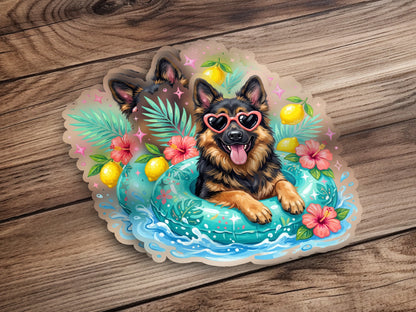 German Shepherd in heart sunglasses floats in pool with tropical flowers and fruit.