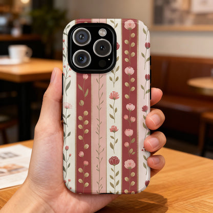 Phone case with a pink and cream floral stripe pattern.