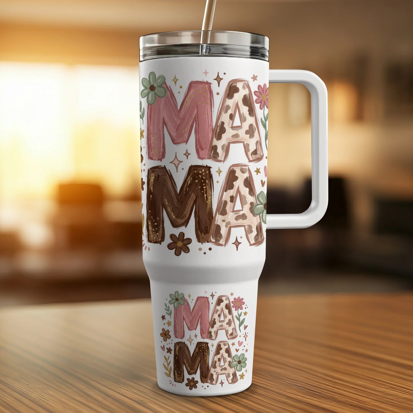 Floral mama tumbler with straw on a wooden surface.