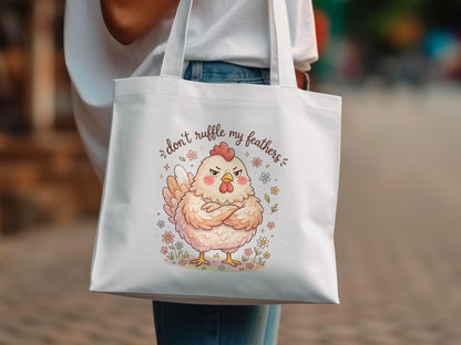 Tote bag with a grumpy cartoon chicken and flowers, saying "Don't ruffle my feathers."