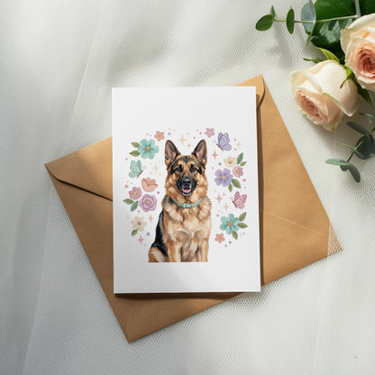 German Shepherd portrait on a card surrounded by flowers and butterflies.