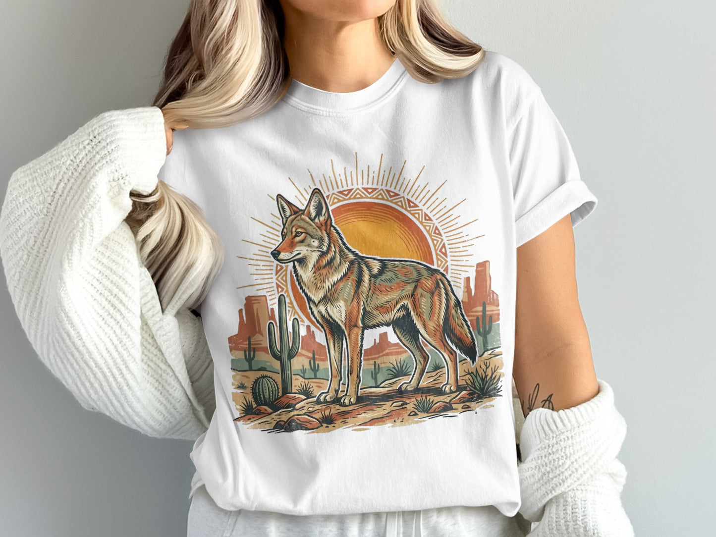 White t-shirt with coyote and desert landscape graphic.