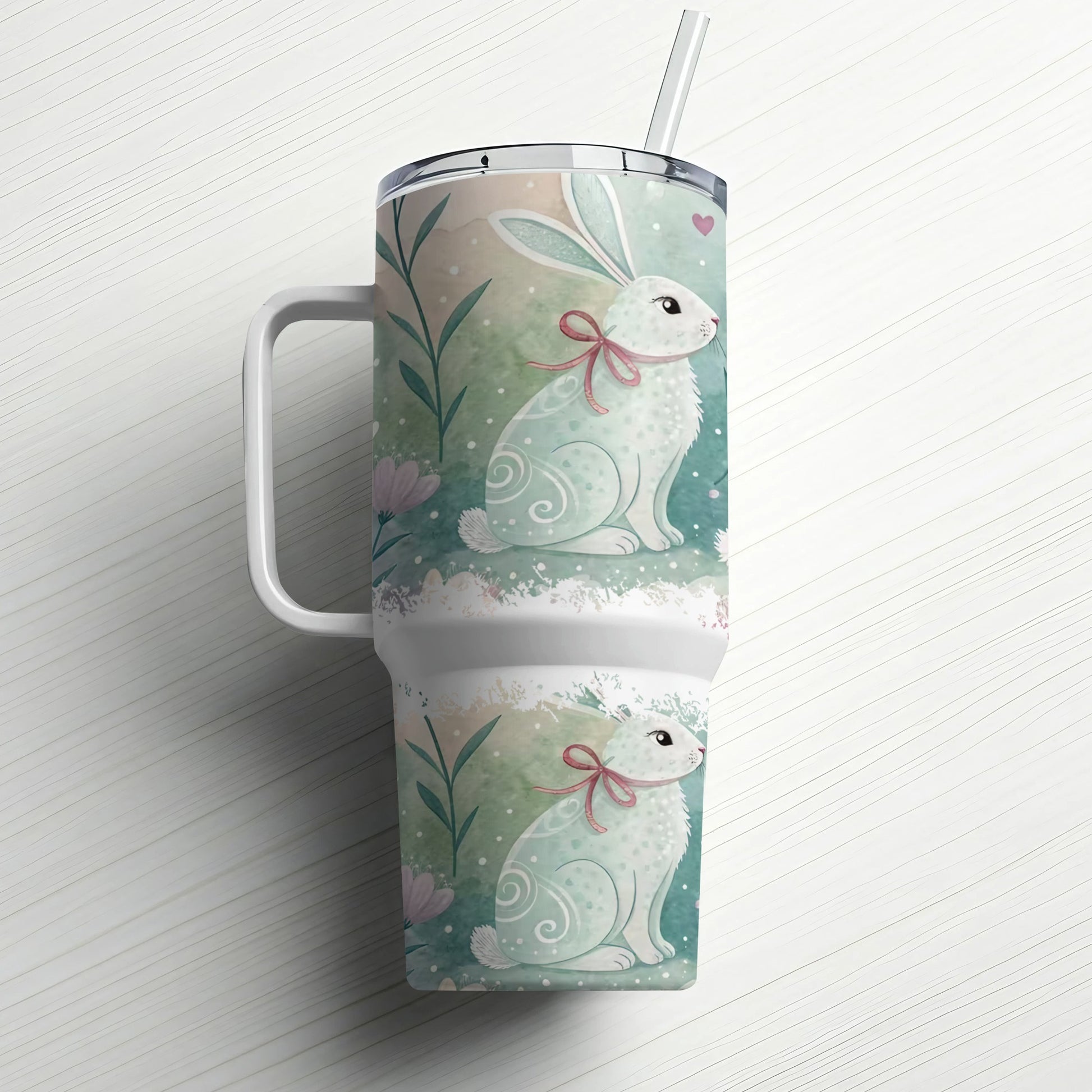 White tumbler with two pastel Easter bunnies, pink bows, and subtle floral accents.