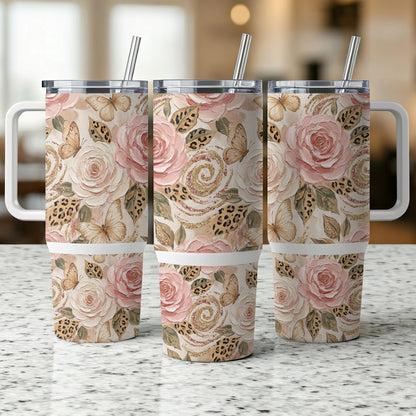 Three floral and butterfly patterned tumblers with handles and straws.