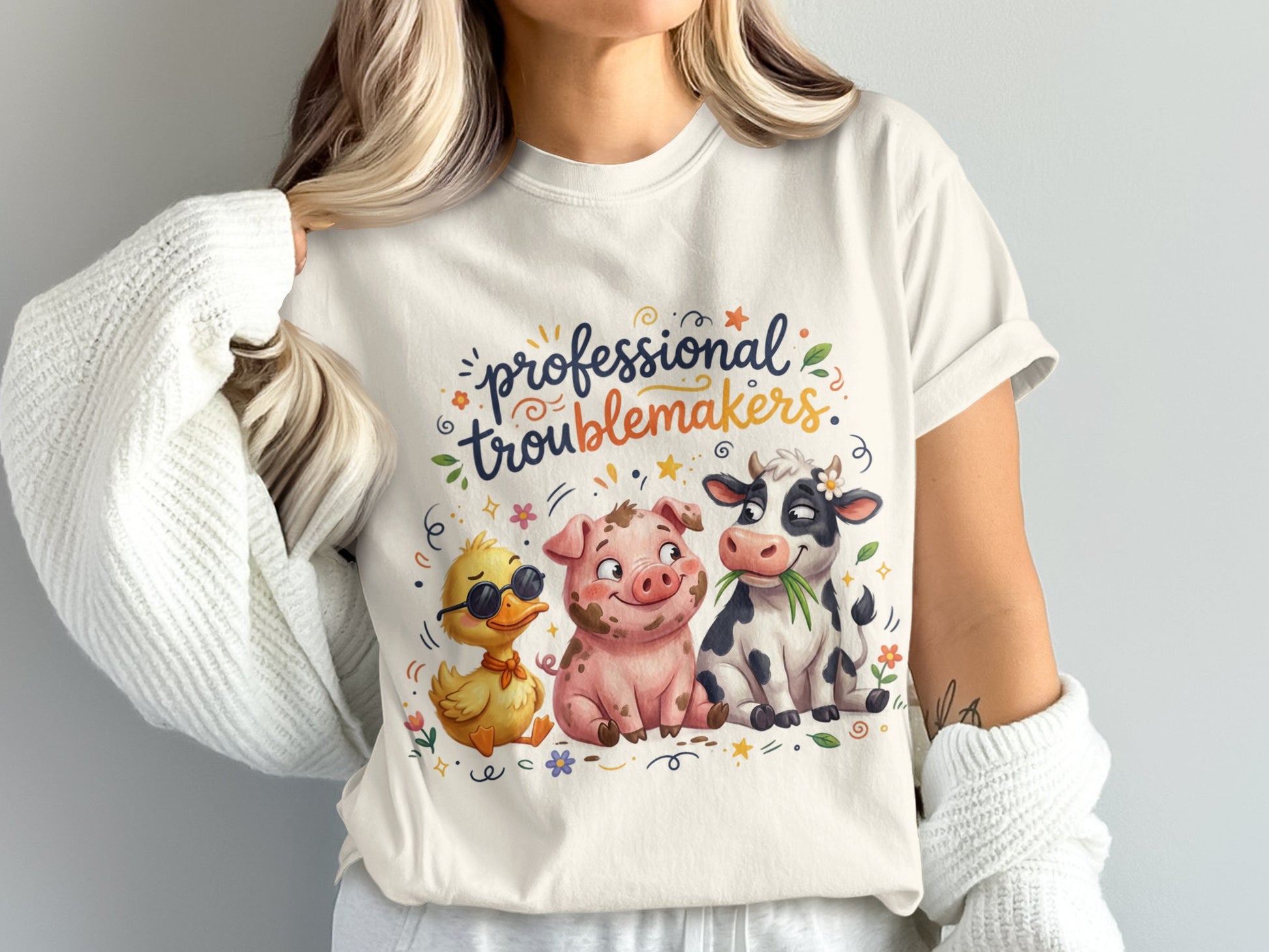 T-shirt with a duck, pig, and cow illustration and "professional troublemakers" text.