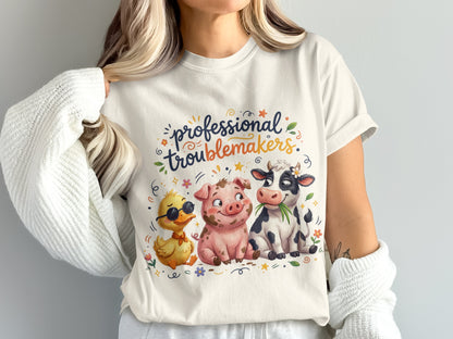 T-shirt with a duck, pig, and cow illustration and "professional troublemakers" text.