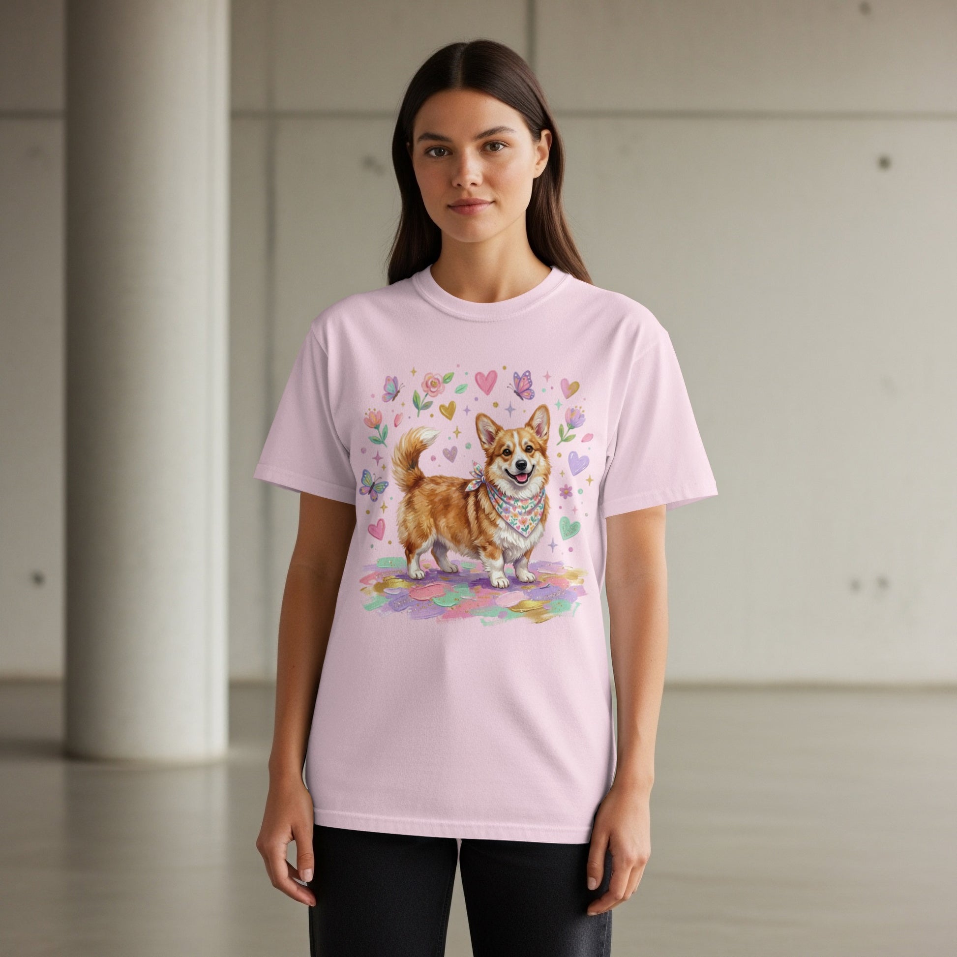 Pink t-shirt with a corgi wearing a bandana surrounded by hearts and flowers.