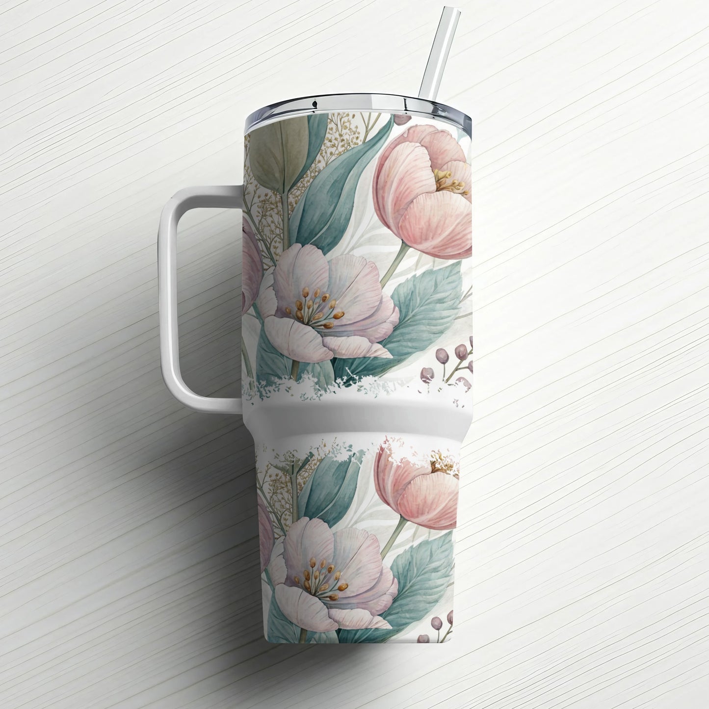 White tumbler with pink floral pattern and straw.