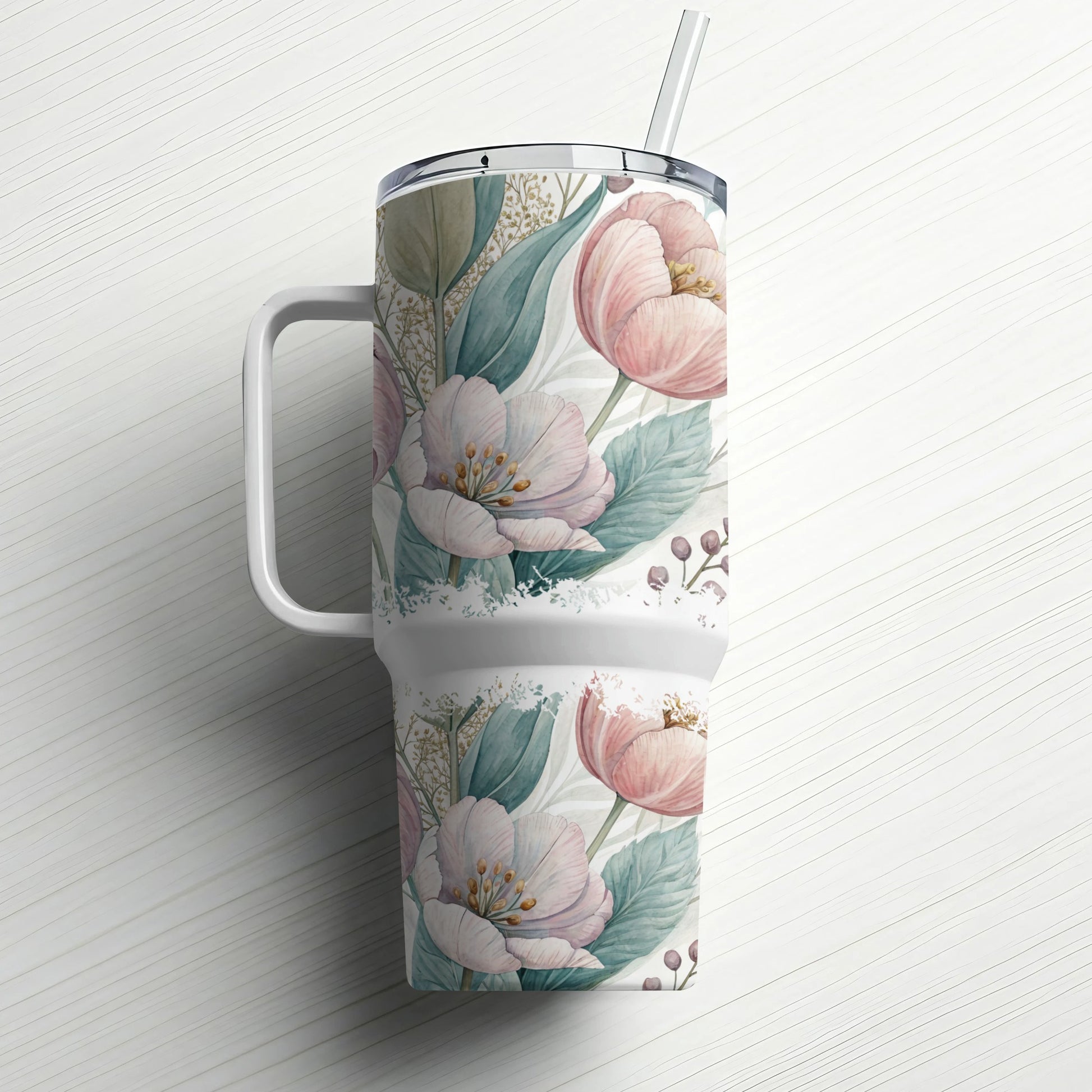 White tumbler with pink floral pattern and straw.