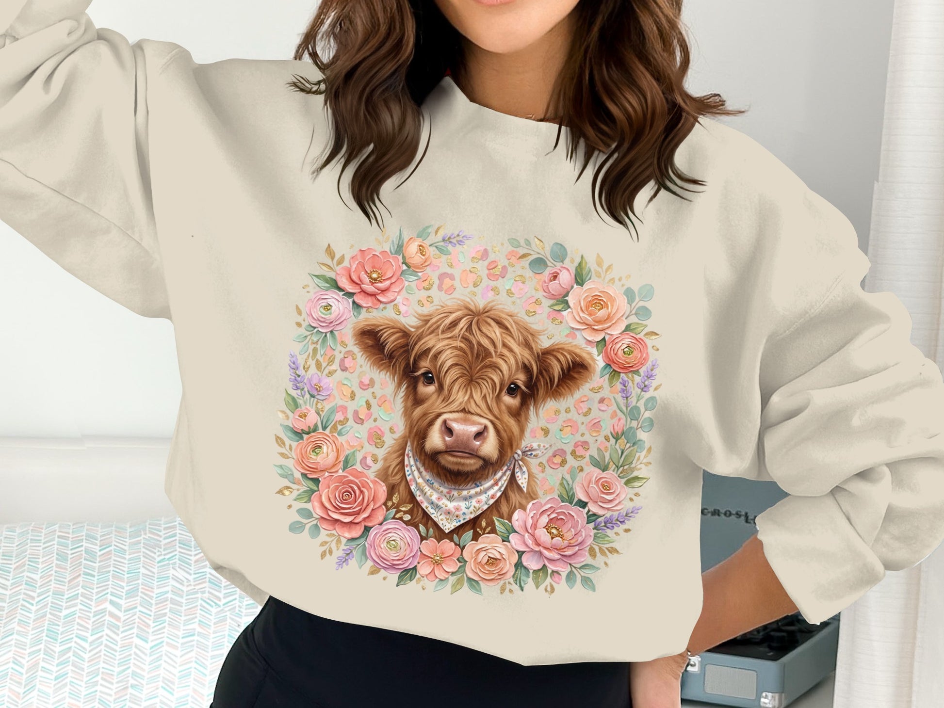 Sweatshirt with a cute cow illustration surrounded by a floral wreath.