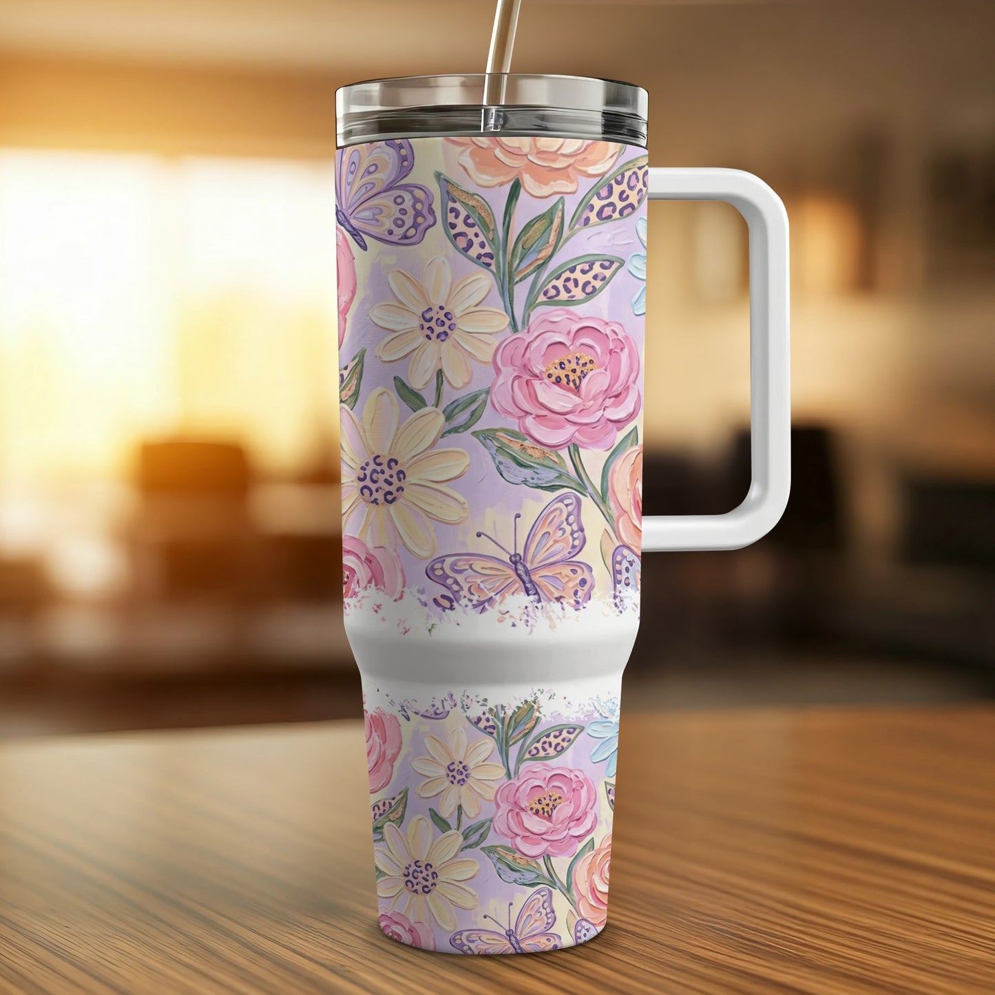 Floral and butterfly patterned insulated tumbler with handle.