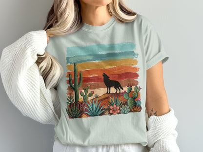 T-shirt with desert scene: wolf howling at colorful sunset, cacti, and succulents.