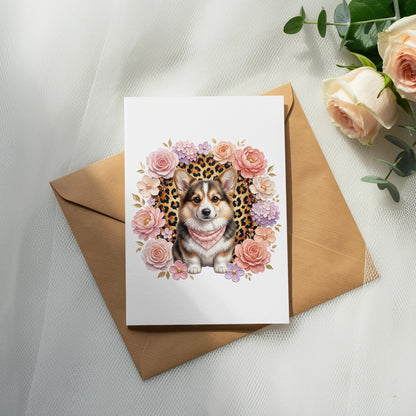 Card with a corgi wearing a bandana, surrounded by flowers, on an envelope.