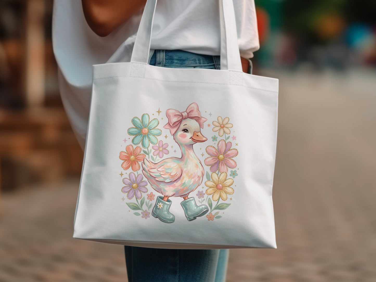 White tote bag with a cartoon duck wearing boots surrounded by pastel flowers.