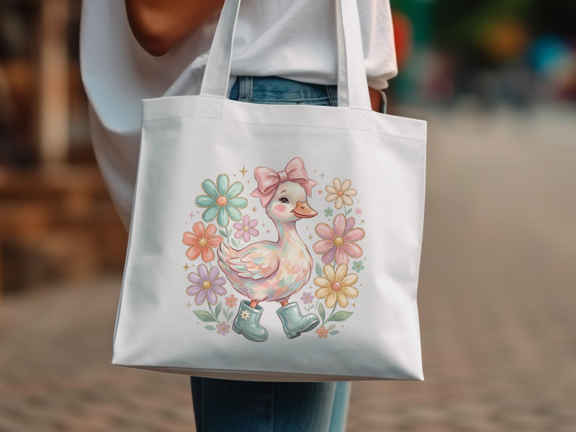 White tote bag with a cartoon duck wearing boots surrounded by pastel flowers.