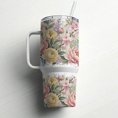 Floral patterned tumbler with a handle and straw, set on a white background.