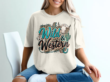 Cream graphic tee with "Wild & Western" text, bull skull, cactus, and playing cards.