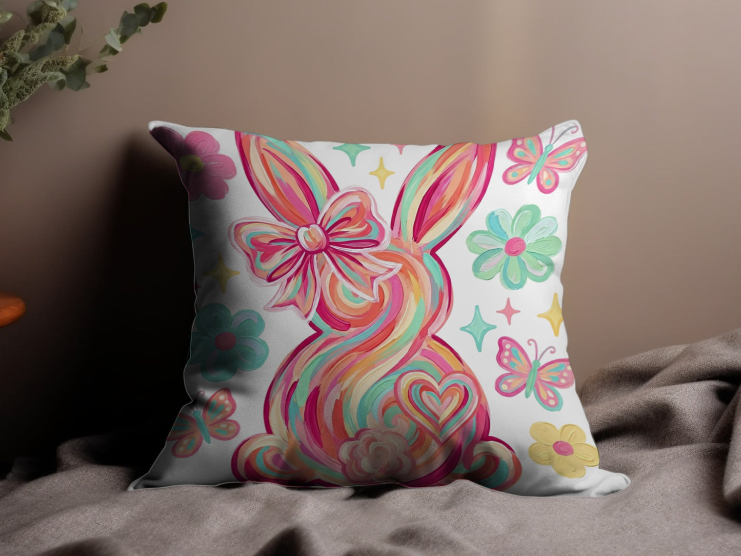 Colorful Easter bunny pillow with flowers and butterflies.