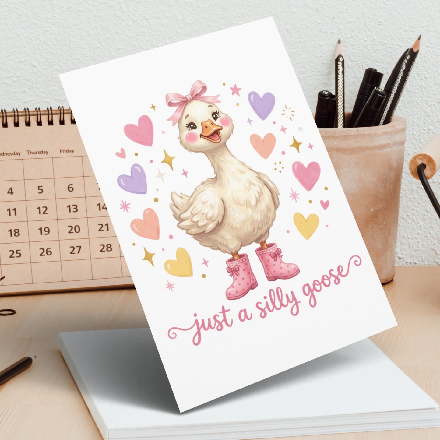 Cute goose with pink bow and boots, "just a silly goose" text.