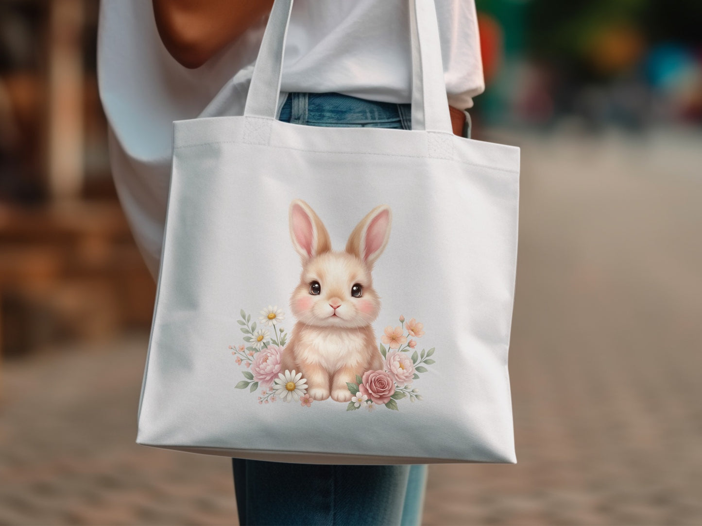 White tote bag with a cute fluffy bunny surrounded by pink and peach flowers.