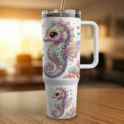 White tumbler with colorful seahorse and coral designs.
