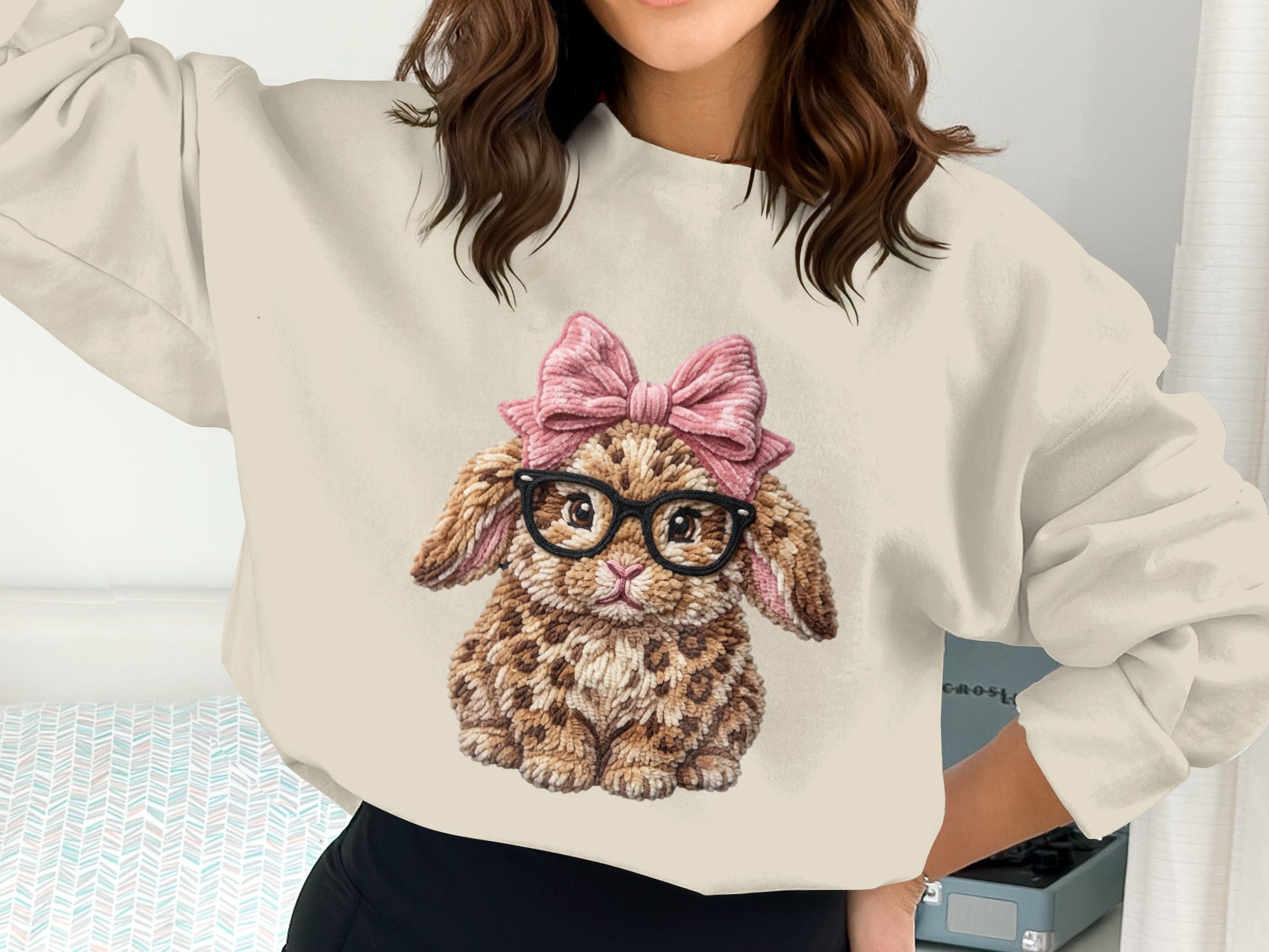Cream sweatshirt with a leopard print bunny wearing a pink bow and glasses.