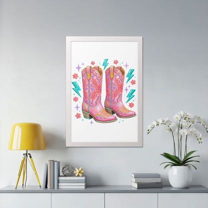 Pink cowboy boots with floral and lightning bolt embroidery in a white frame.