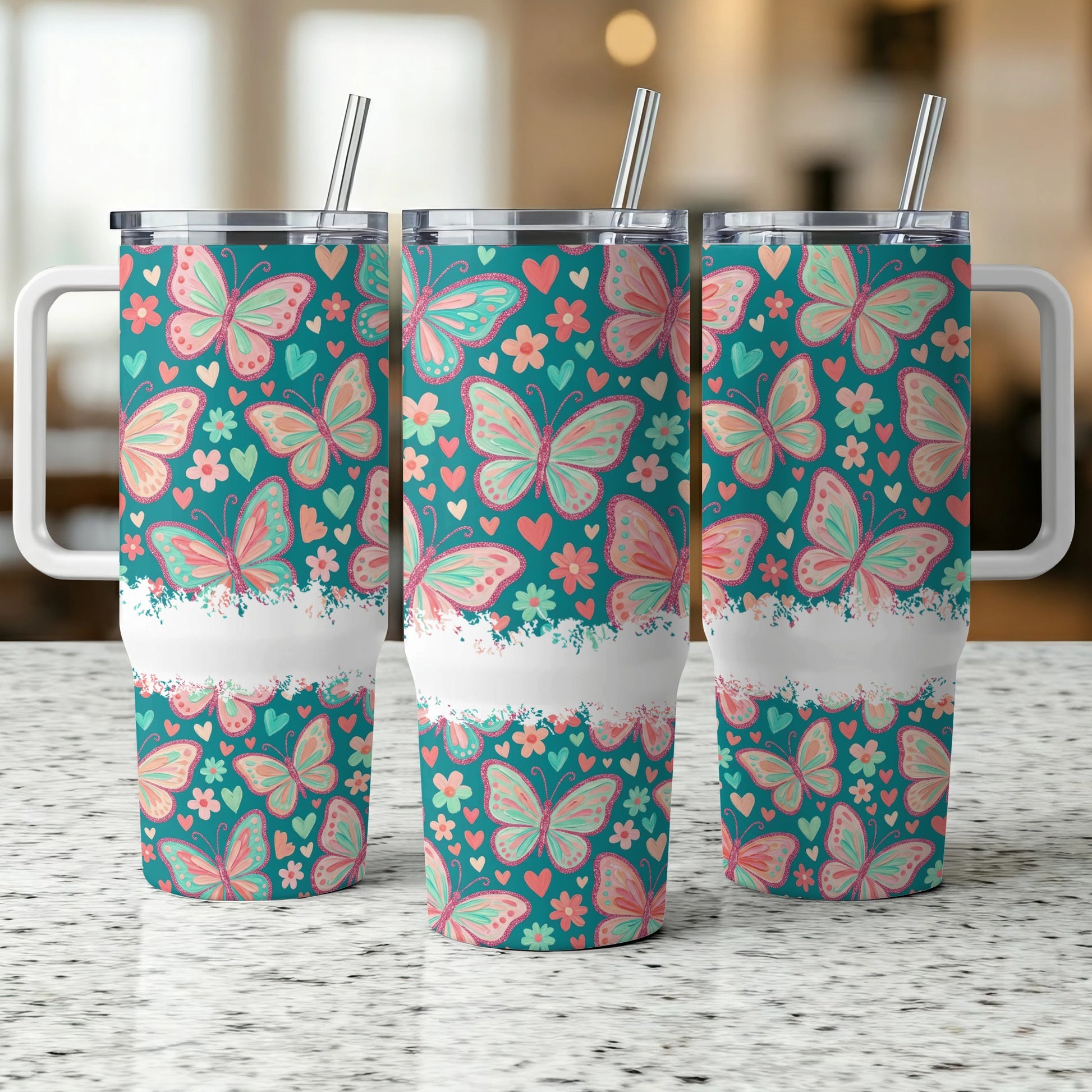 Three tumblers with pink and green butterflies on teal background.