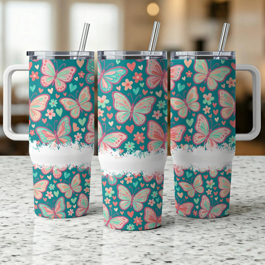 Three tumblers with pink and green butterflies on teal background.