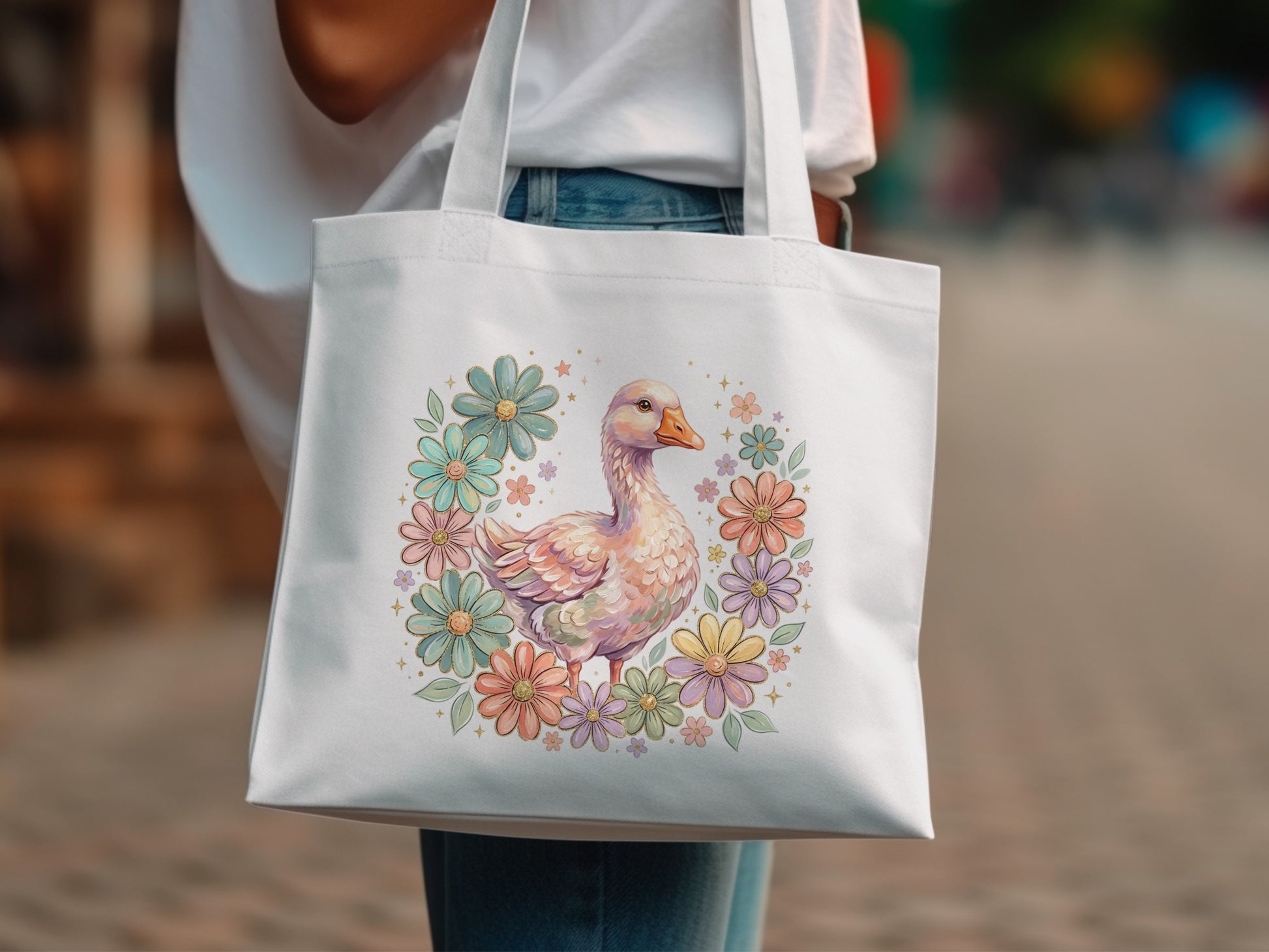 White tote bag with a goose illustration surrounded by pastel flowers.