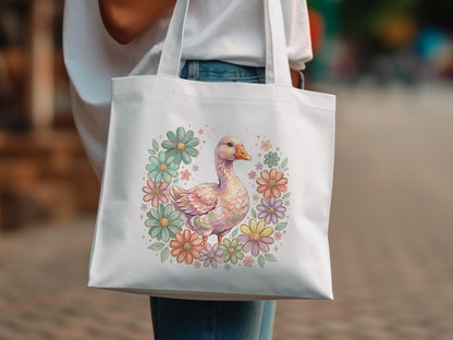 White tote bag with a goose illustration surrounded by pastel flowers.