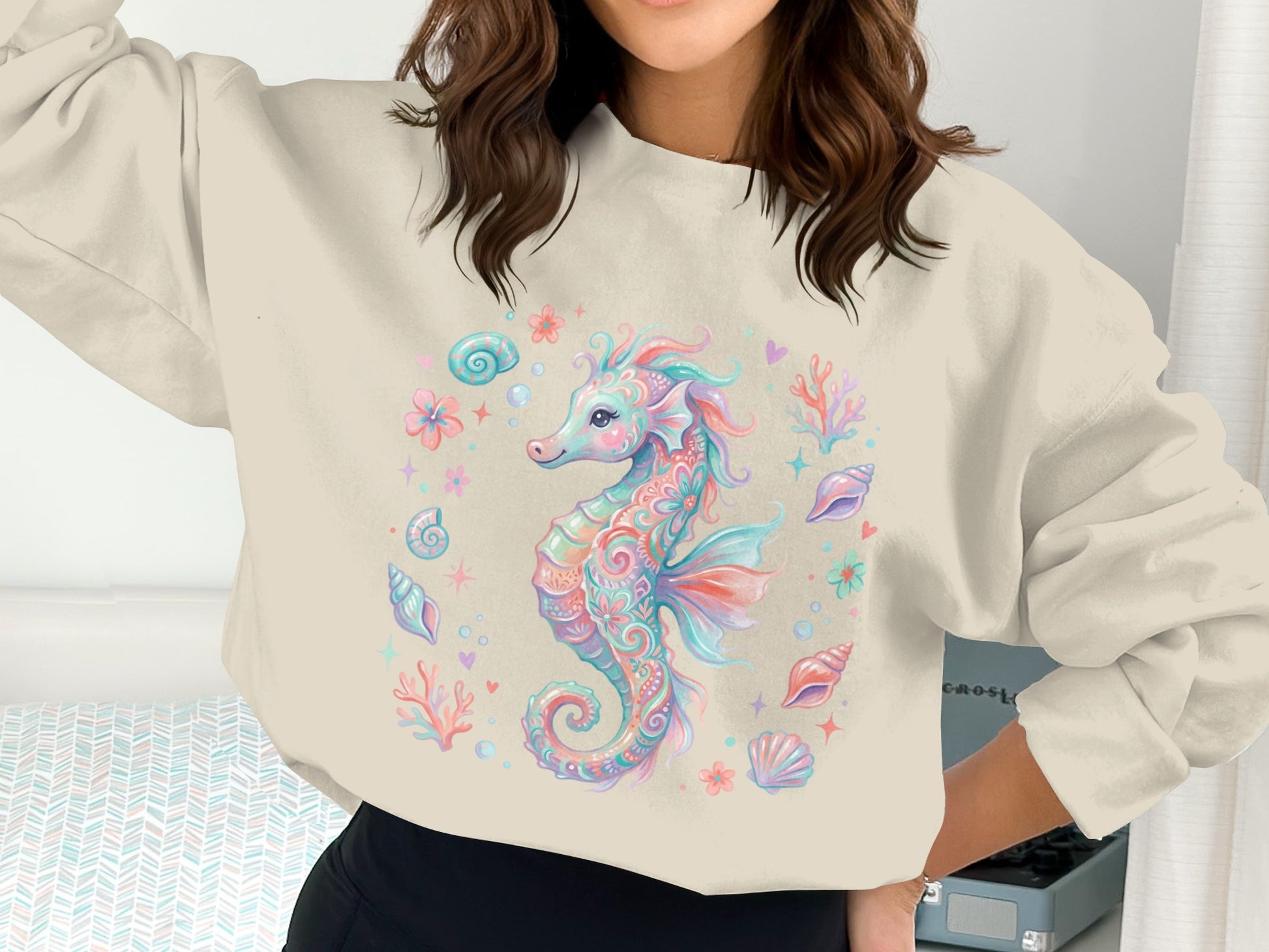 Cream sweatshirt with pastel seahorse and seashell graphic.