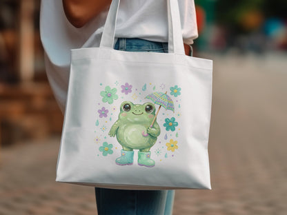 White tote bag with a smiling frog holding an umbrella and wearing boots.