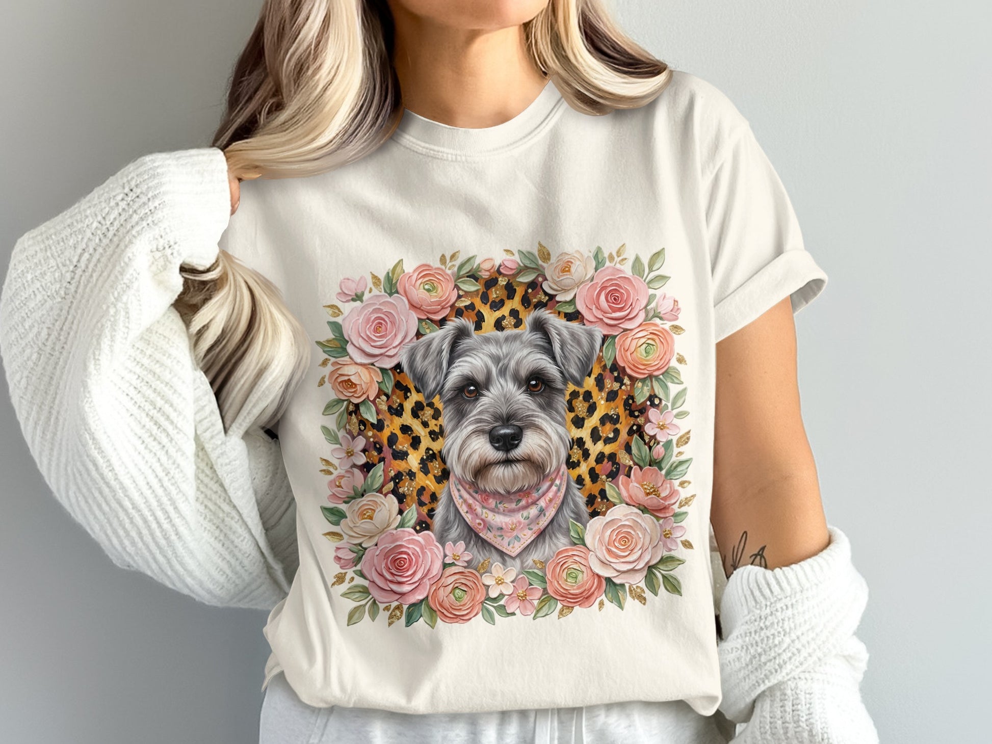 Schnauzer dog wearing bandana surrounded by floral wreath on cream t-shirt.