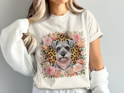Schnauzer dog wearing bandana surrounded by floral wreath on cream t-shirt.