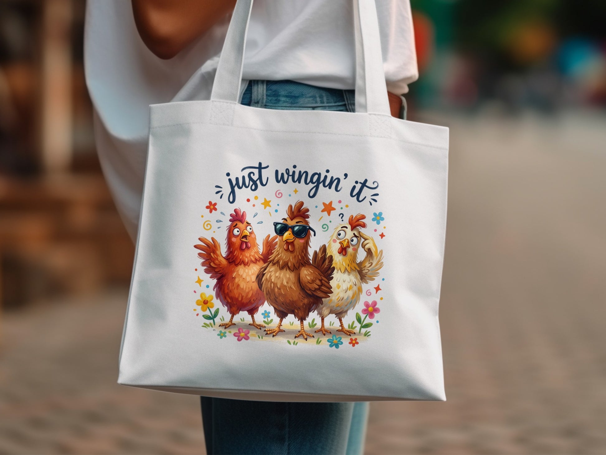 White tote bag with three cartoon chickens and "just wingin' it" text.