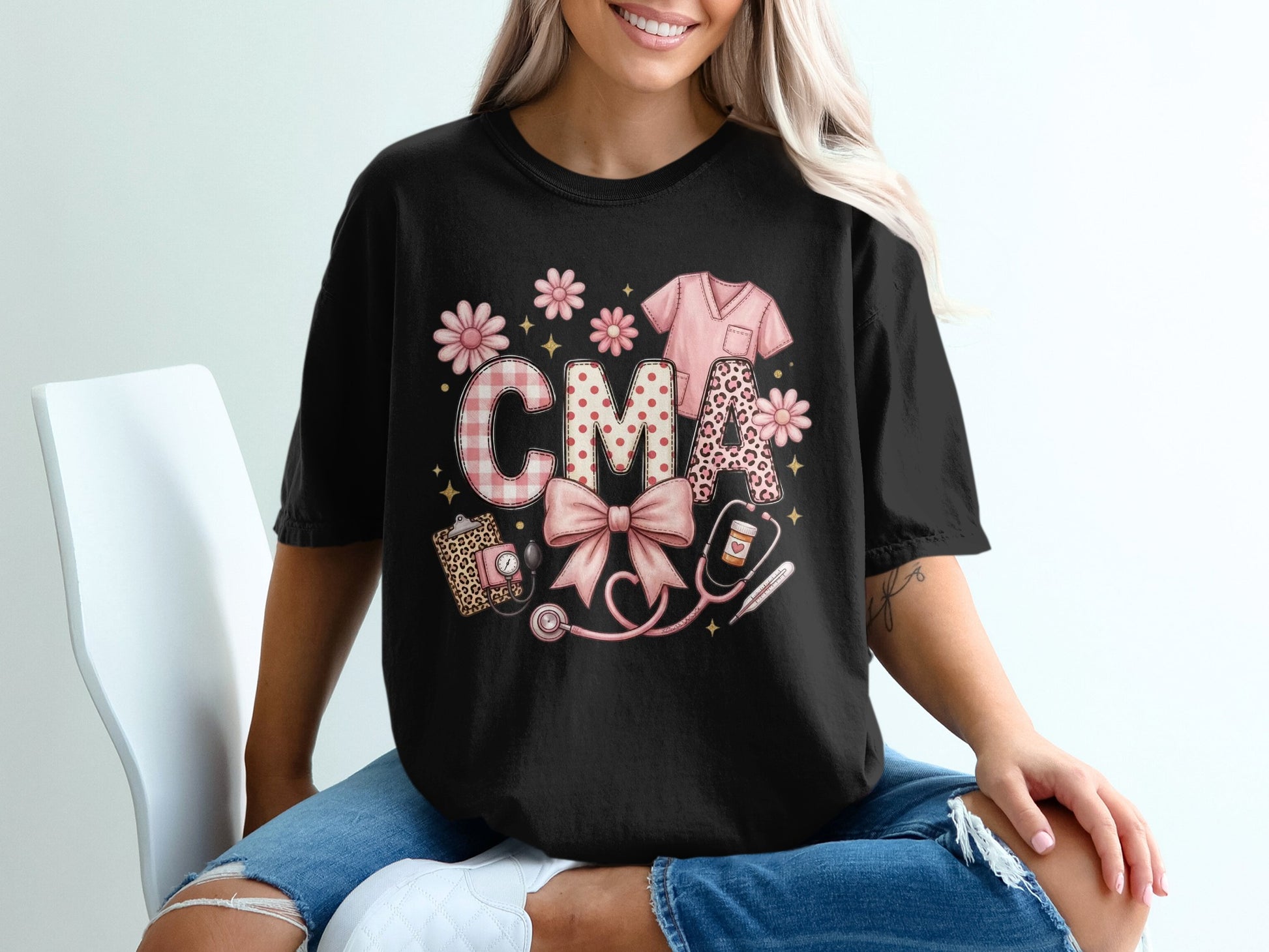Black t-shirt with "CMA" in pink gingham, leopard print, and floral letters.