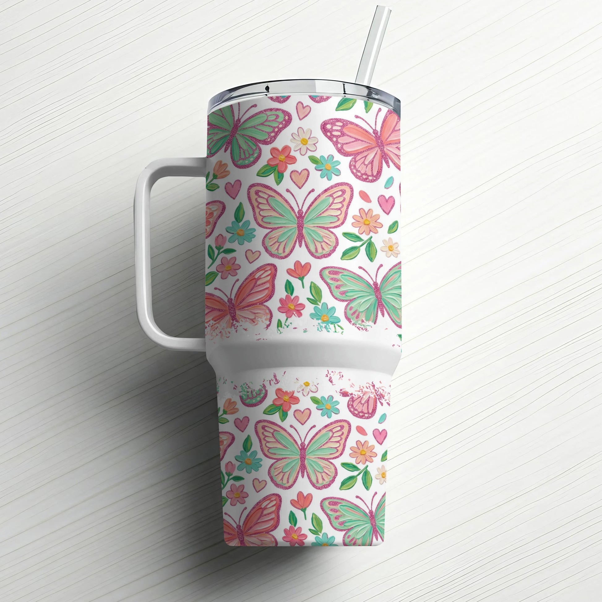 White tumbler with colorful butterflies and floral pattern, includes straw.