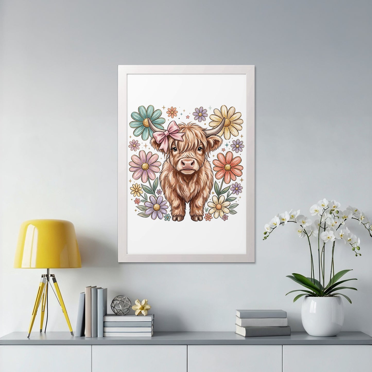 Whimsical highland cow with flowers and a bow in a white frame.