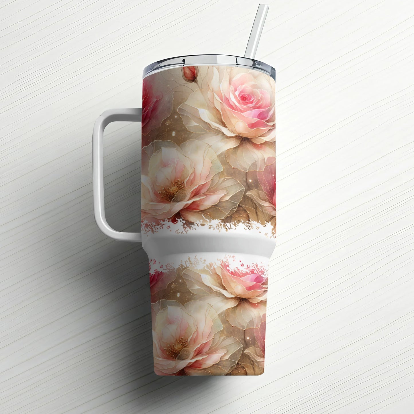 Large insulated tumbler with pink roses and a straw.